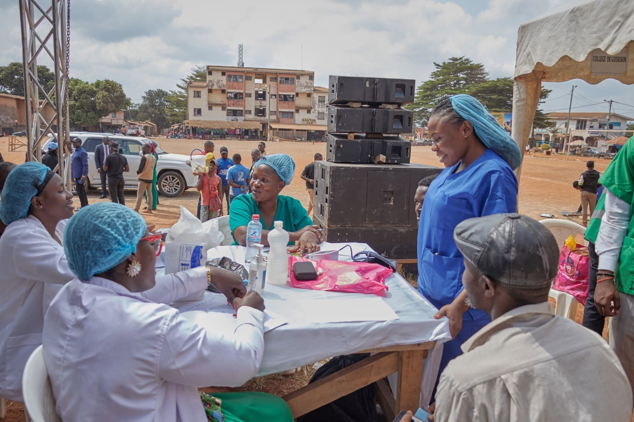 Volunteers at an outdoor table caring for people in the community